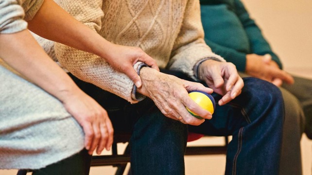 Picture1 Senior man squeezing ball with female carer checking pulse