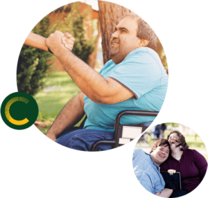 Claro-Queensland1 A man and woman with disabilities sitting close and laughing and a man with a disability in a wheelchair smiling and holding someone's hand