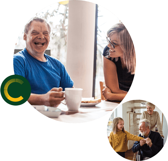 Claro-Victoria2 A man with a disability laughing and holding a cup of coffee while a woman stares at him smiling and a little girl holding the hand of an older man in a wheelchair with an older woman pushing from behind, all are smiling