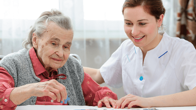 Picture1-4 Senior female solving a jigsaw puzzle with a nurse