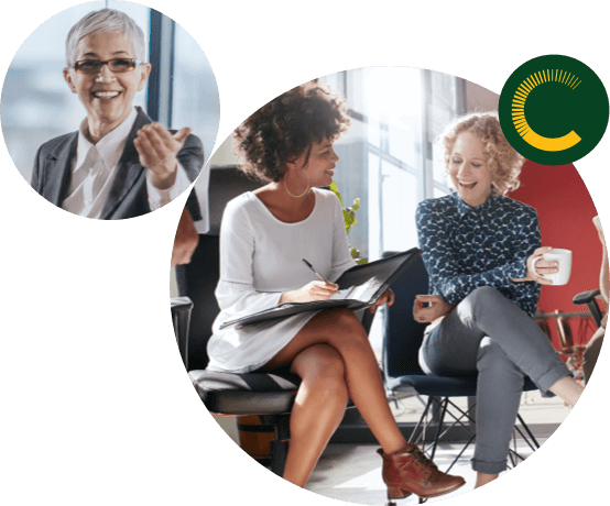 careers Older woman smiling while offering her left hand and two business women sitting down and laughing