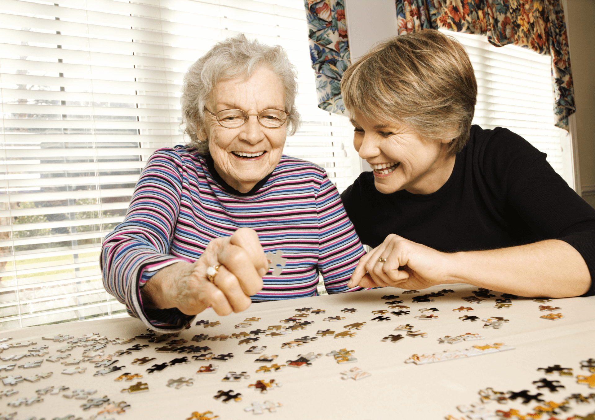 understanding-dementia Three students sit on one side of a table studying. They are looking down at a notebook